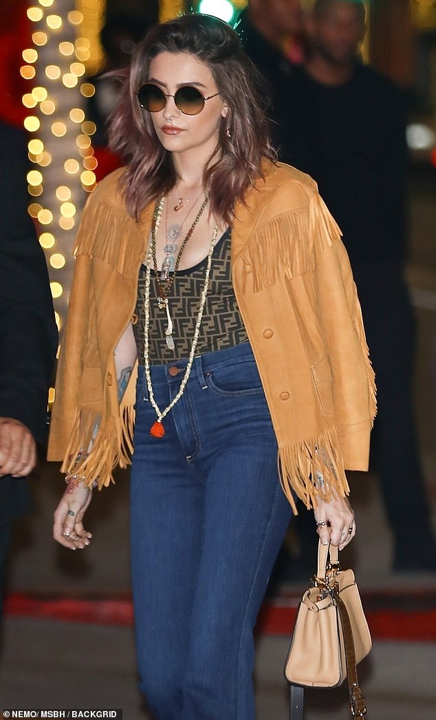 Keeping with her penchant for 1960s style, the self-professed 'treehugger' reached back to her inner Hippie with a brown-fringe suede jacket