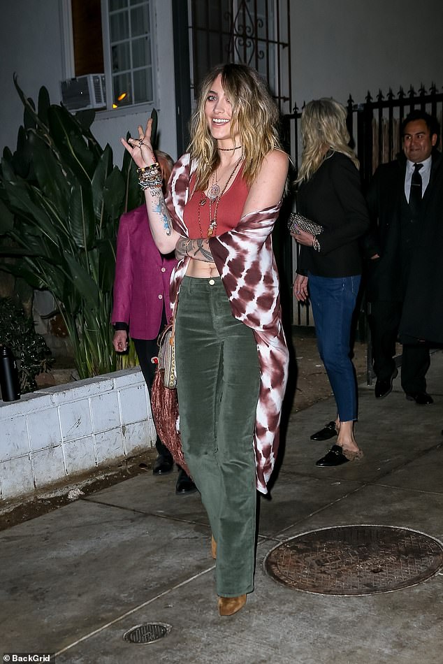 Paris Jackson created a 1970s hippy vibe in a maroon tie-dye shawl and dark green flares as she attended Sara Foster's birthday dinner in Hollywood